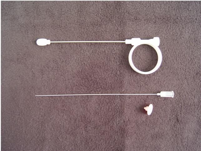 Iowa Trumpet (top), Needle (middle), and plastic needle spacer to limit depth of penetration of the needle to 5 mm.
