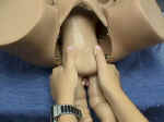 Grasp the baby so that your thumbs are over the baby's hips